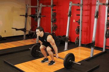 Barbell Hack Squat exercise demonstration targeting Quadriceps